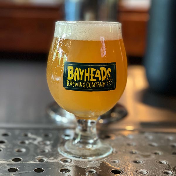 A glass of beer with bayheads logo
